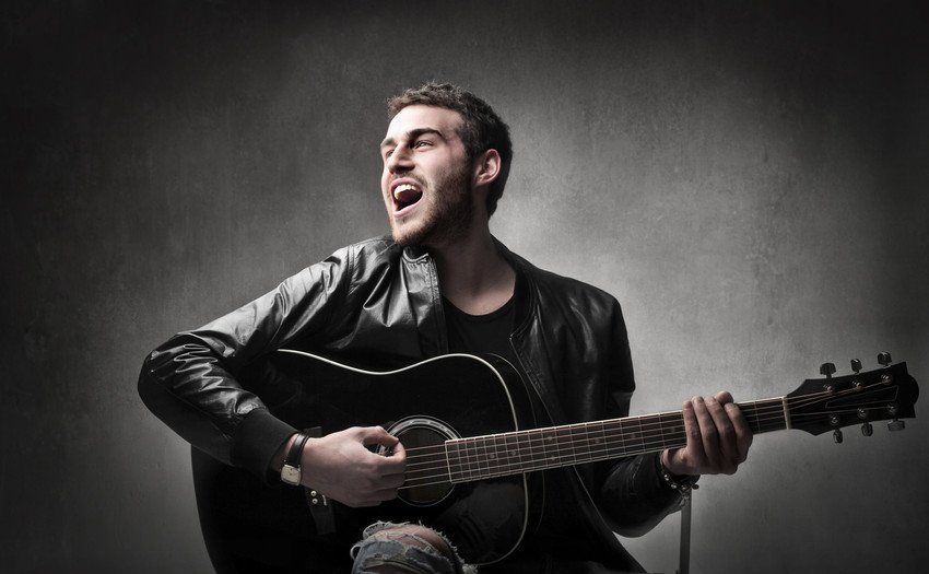 man singing with guitar