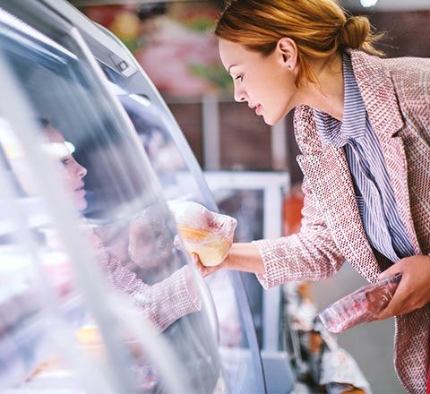 Woman Buying Frozen Goods — Sutherlin, VA — Elite Refrigeration Services, LLC.