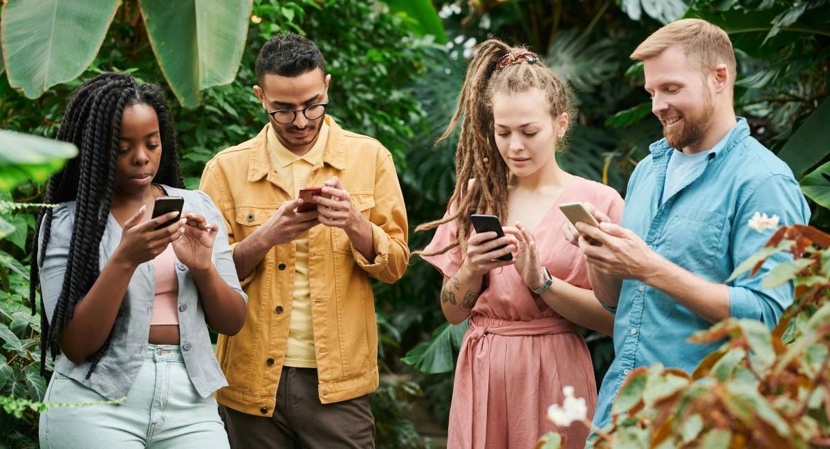 a group of young people checking their mobile phones 