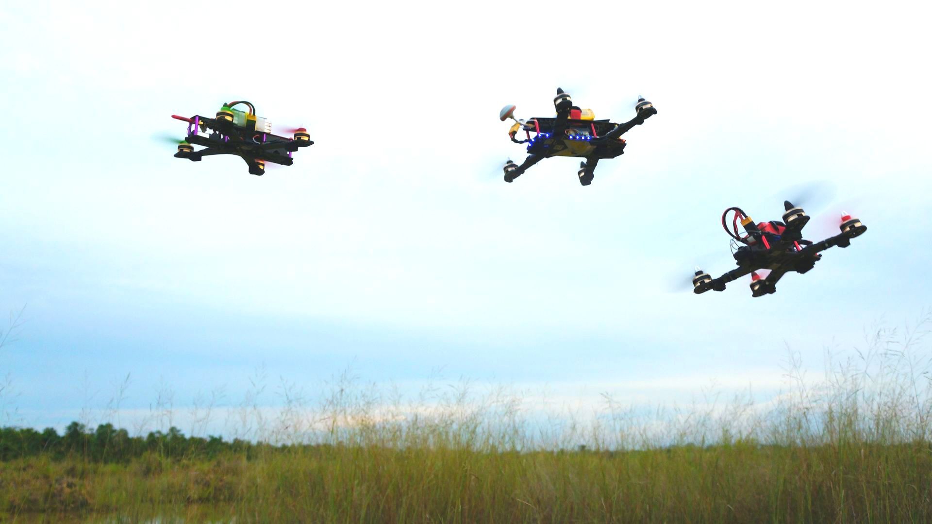 Drone racing over the green field.