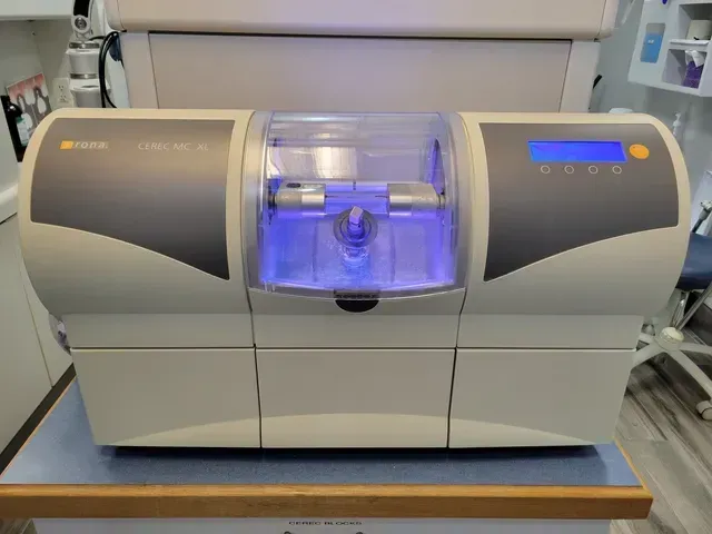 A dental machine is sitting on a table in a dental office.