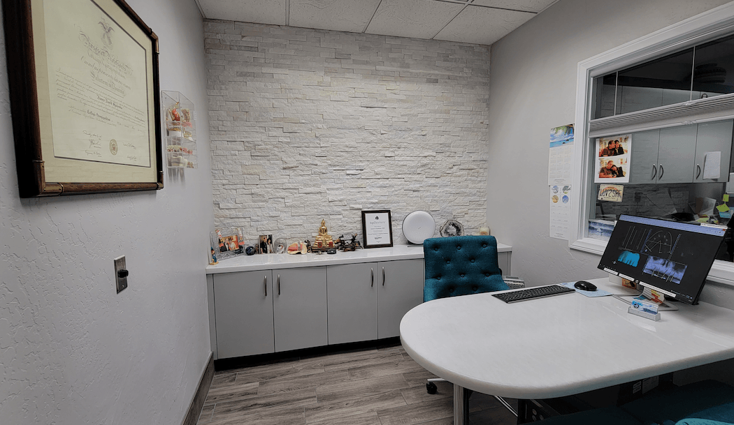 There is a picture on the wall above the desk in the room.