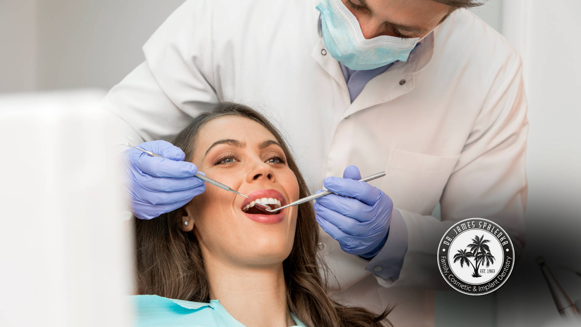 A woman is getting her teeth examined by a dentist.