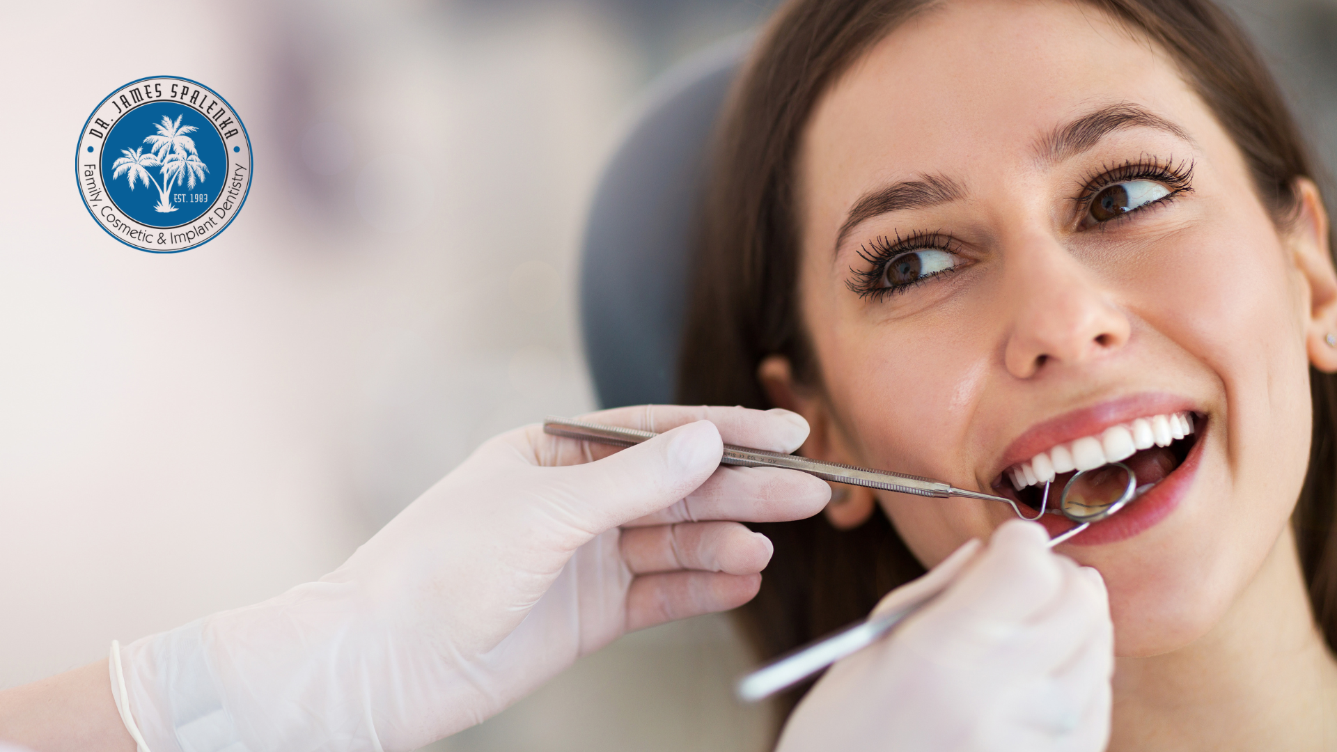 A woman is getting her teeth examined by a dentist.