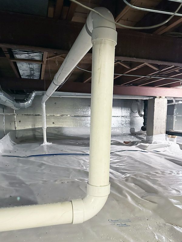 A basement with a lot of pipes coming out of it.