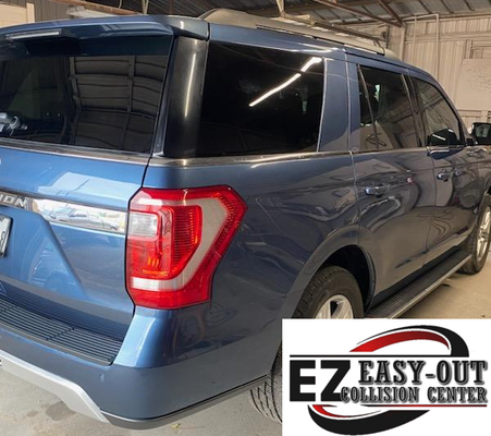 Blue SUV at EZ Easy-Out Collision Center, rear view.