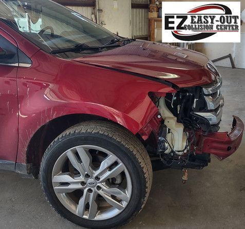 Red Ford Edge with front-end damage, likely after a collision. The 