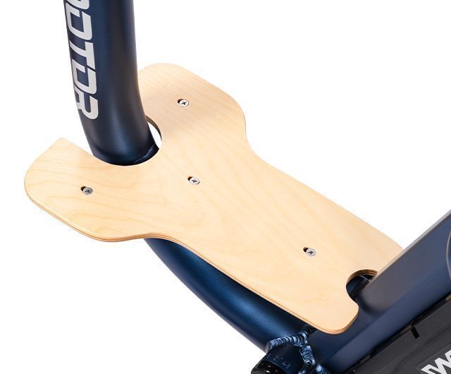 Close-up of a light wood bike frame plate with bolts around a black tube.