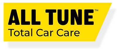 The all tune total car care logo is yellow and black.