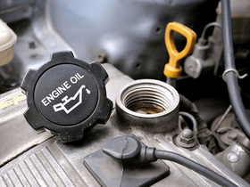 A close up of an engine oil cap on a car