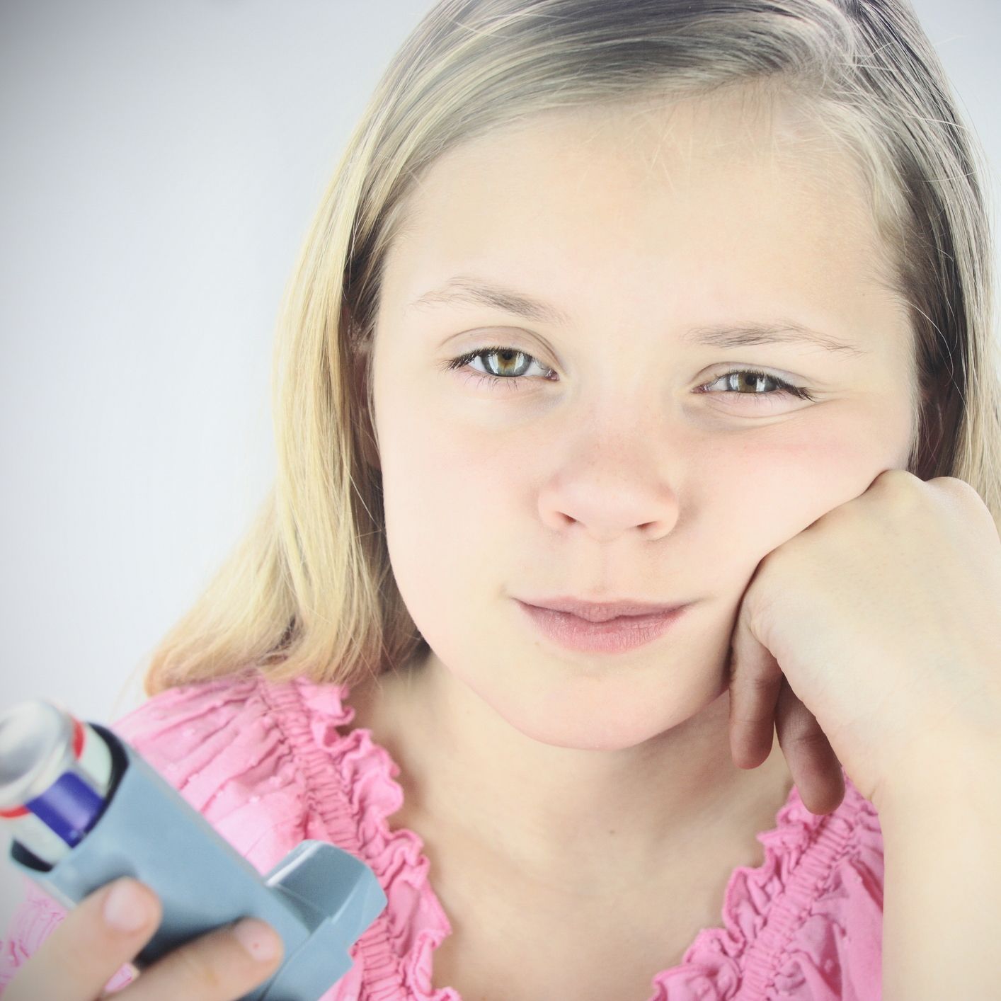 Young girl disappointed in having to use inhaler