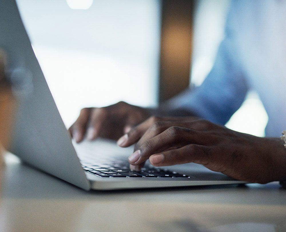 Man Working on A Laptop — Vacaville, CA — AMG Institute LLC
