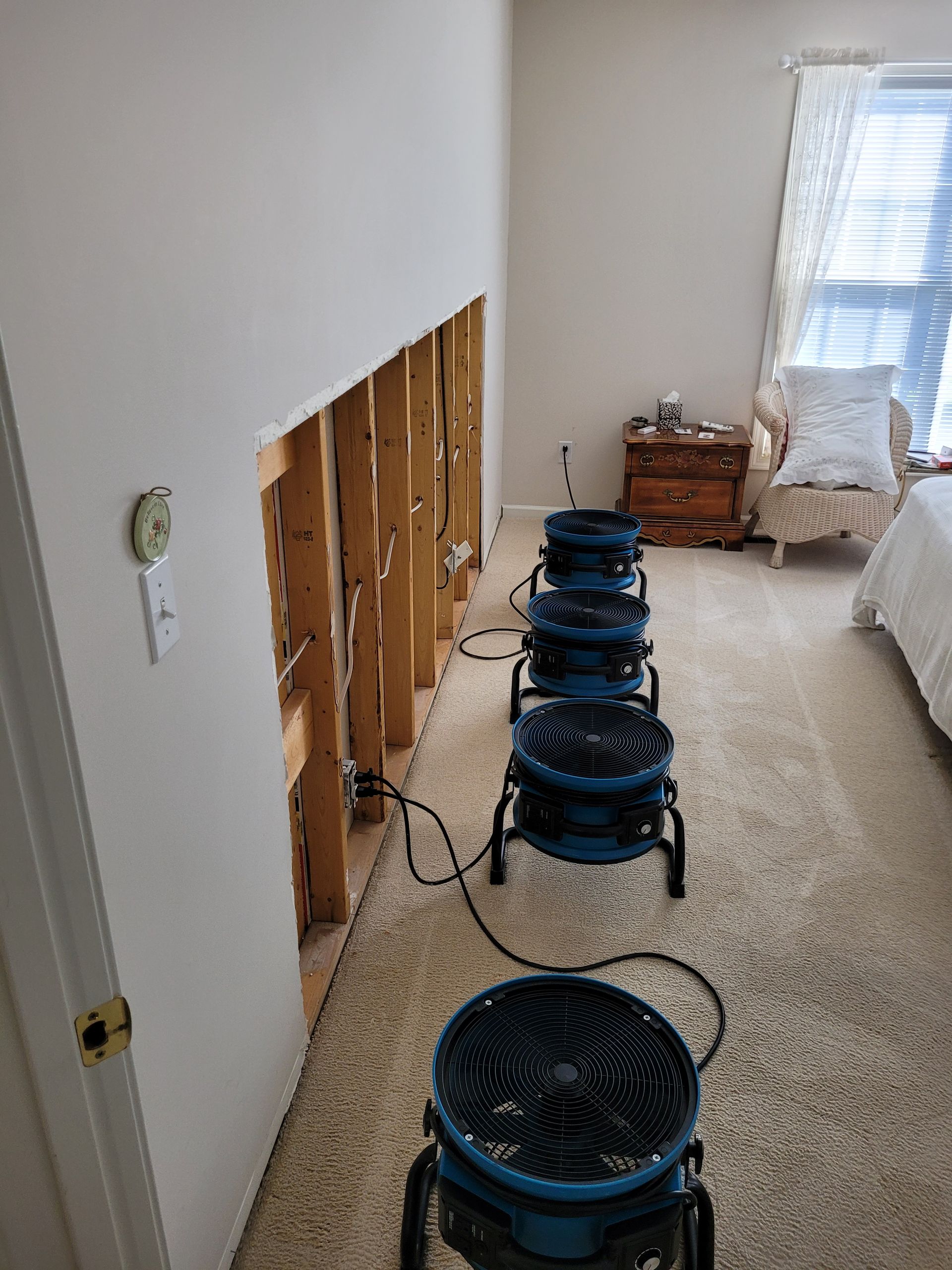 A Man Is Fixing a Water Heater in A Bathroom | Watervliet, MI | Mr. Cleans Restoration