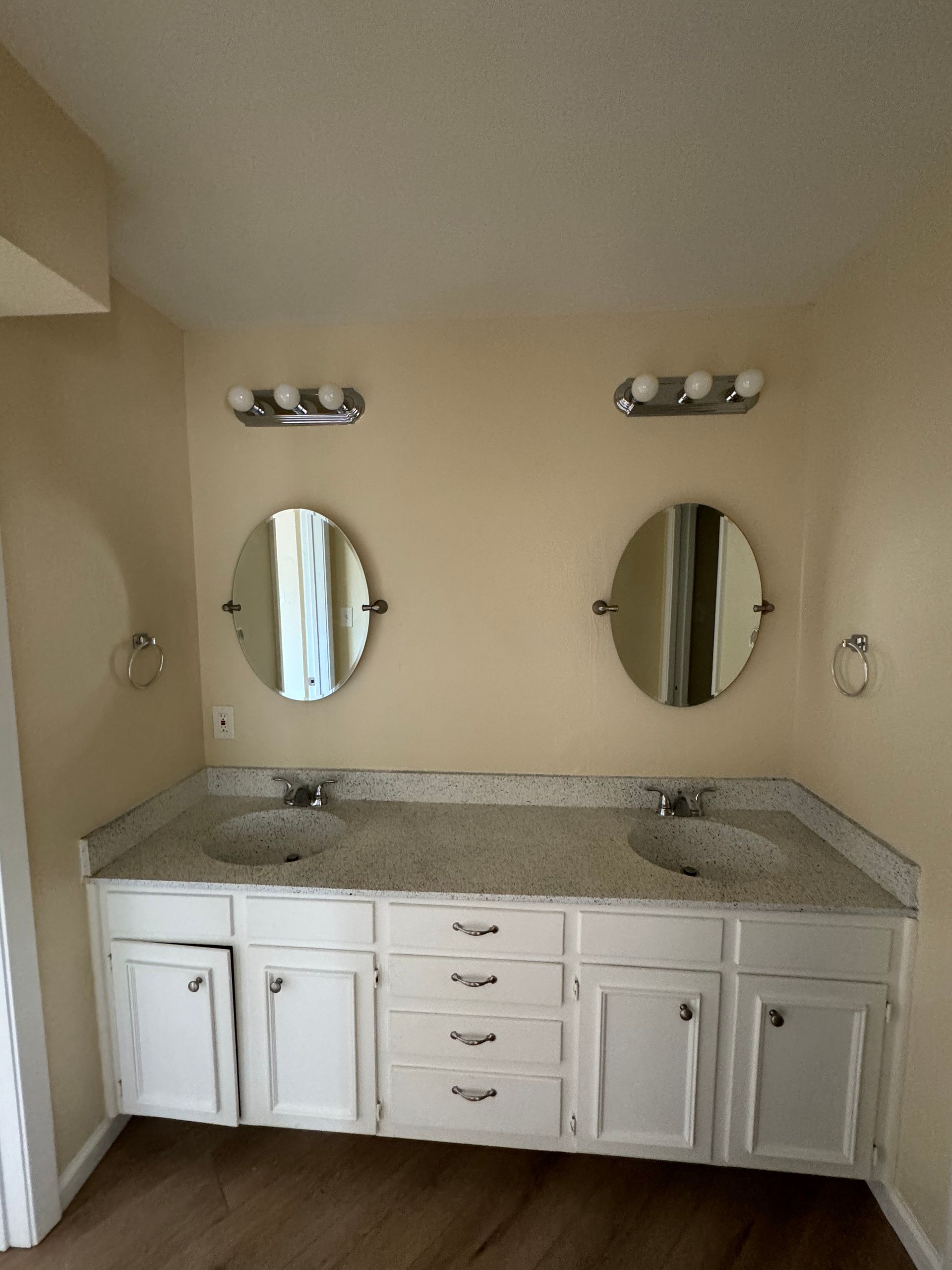 A bathroom with two sinks and two mirrors