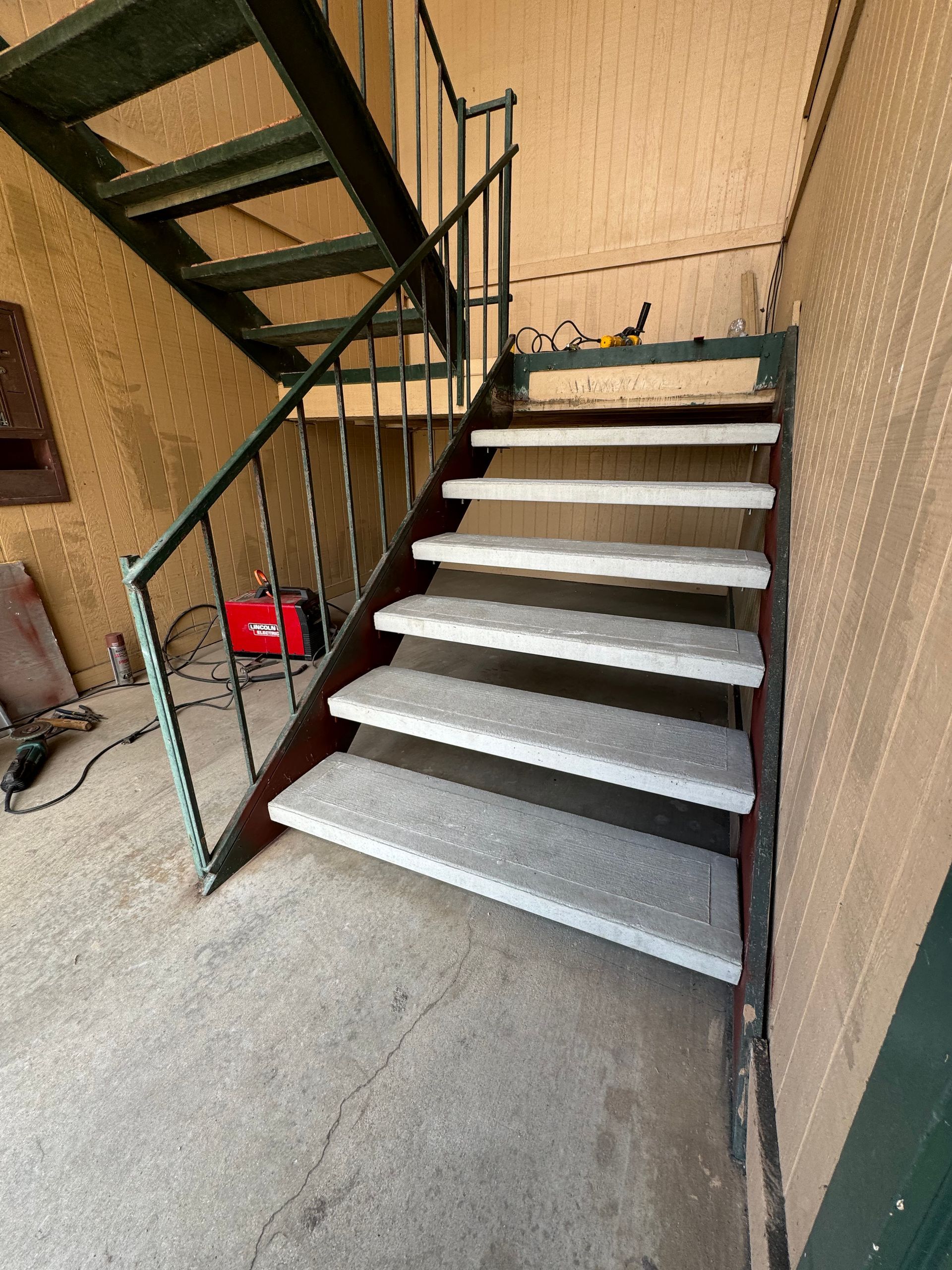 A set of stairs with white steps leading up to a building.