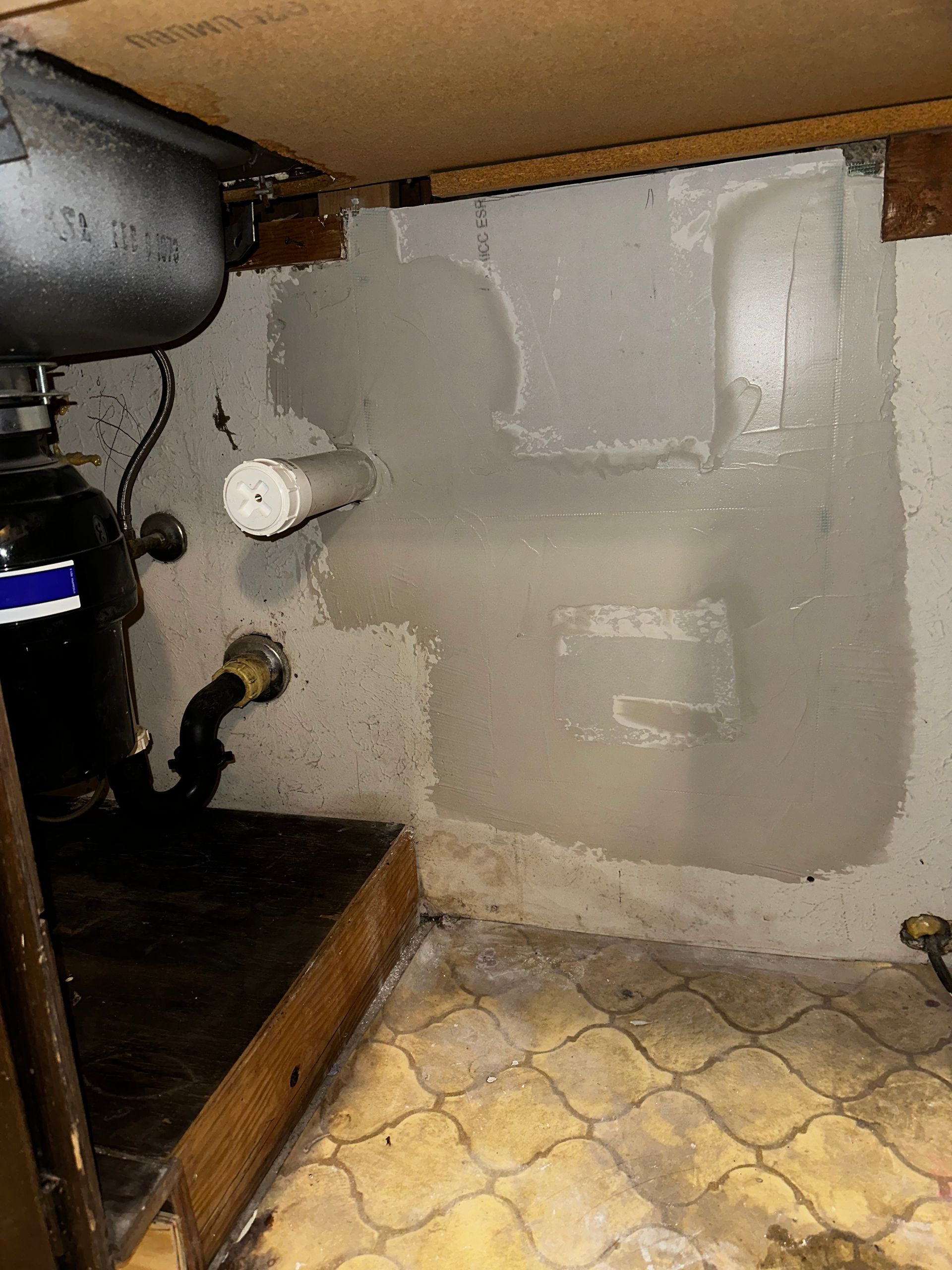 A sink is under a cabinet in a bathroom.