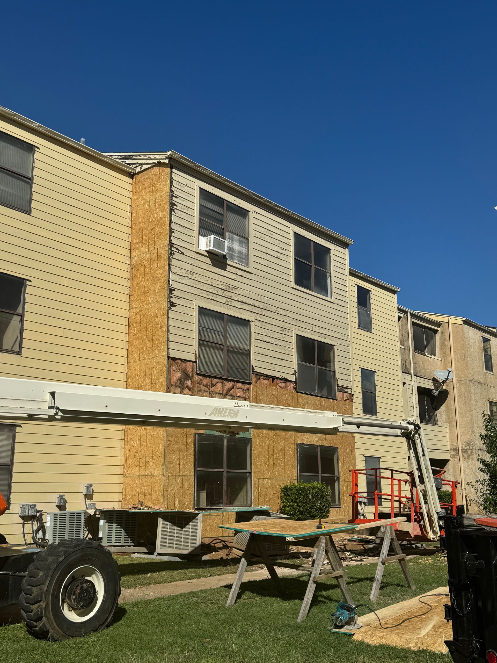 A large building with a lot of windows is being remodeled.