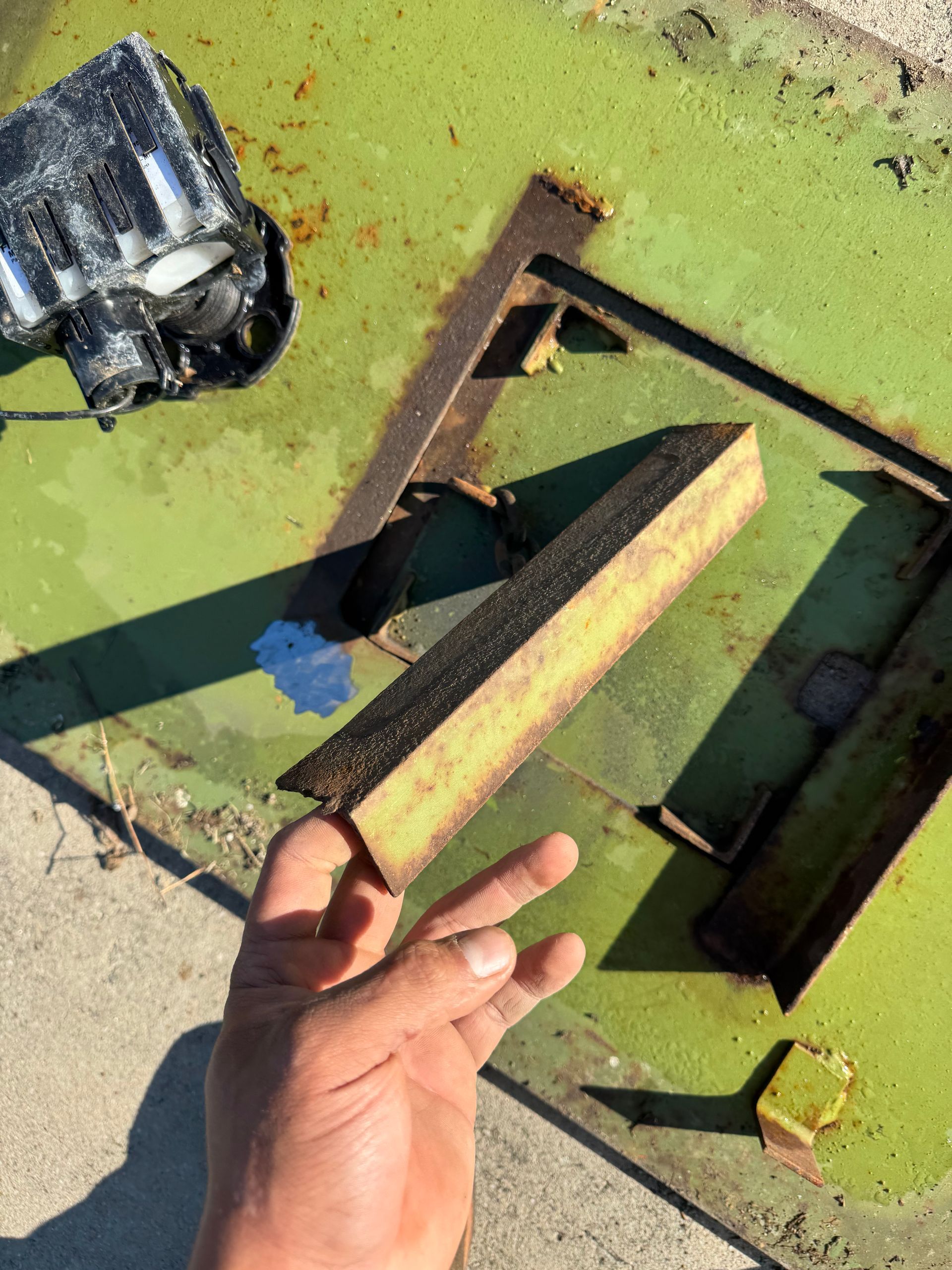 A person is holding a piece of metal in their hand