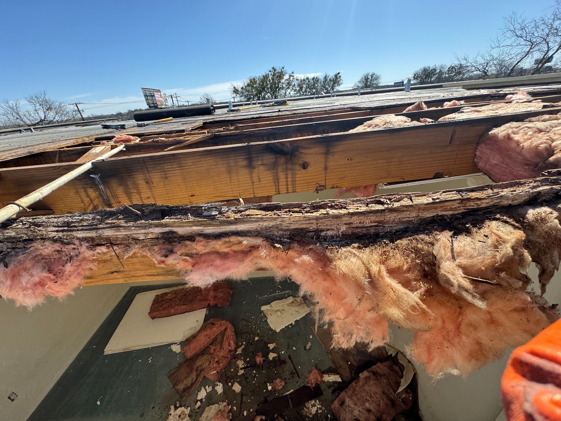 A roof with a lot of insulation coming out of it.