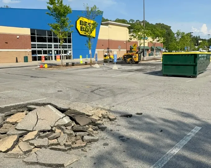 A parking lot with a best buy store in the background