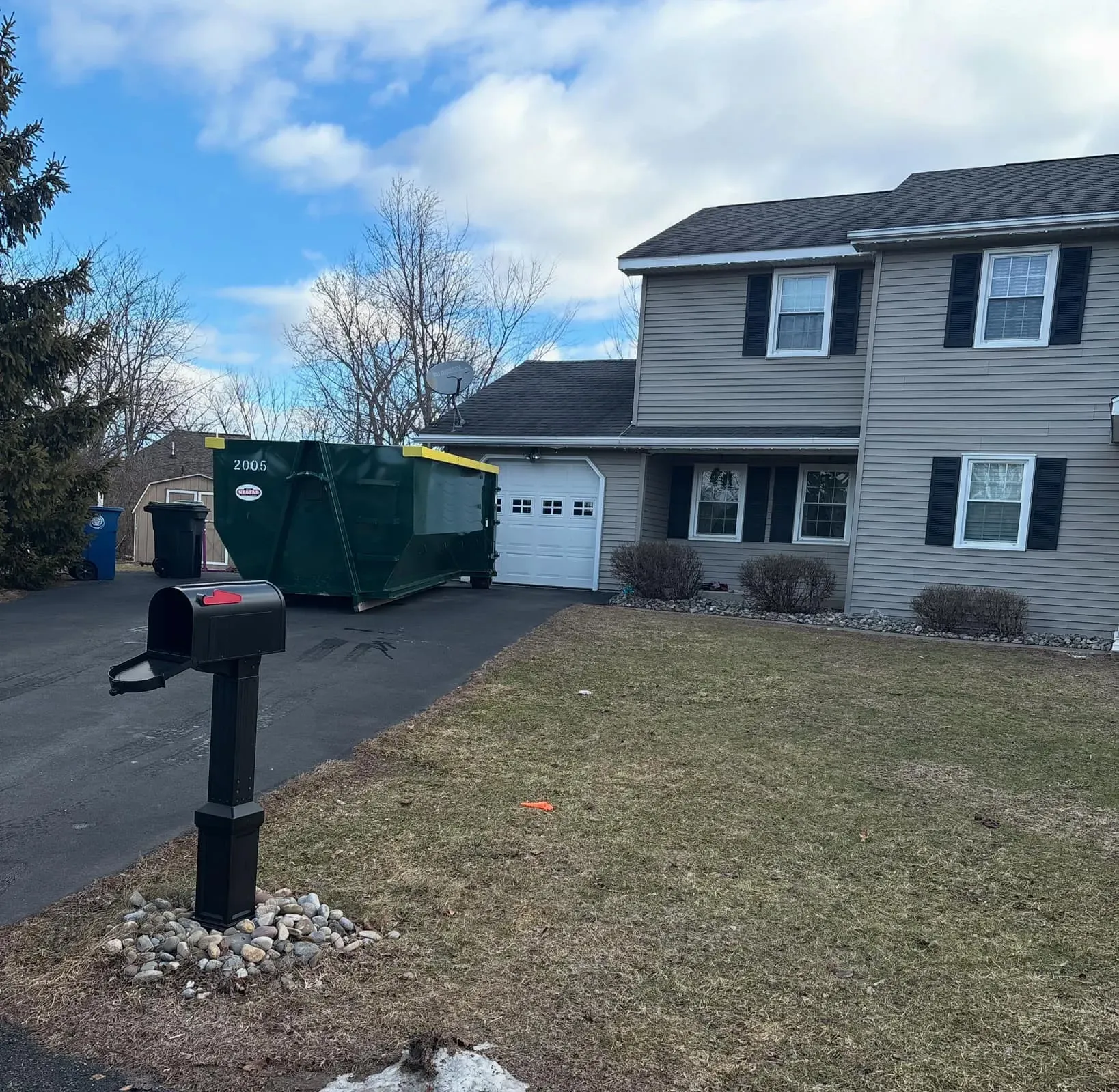 A large house with a mailbox in front of it