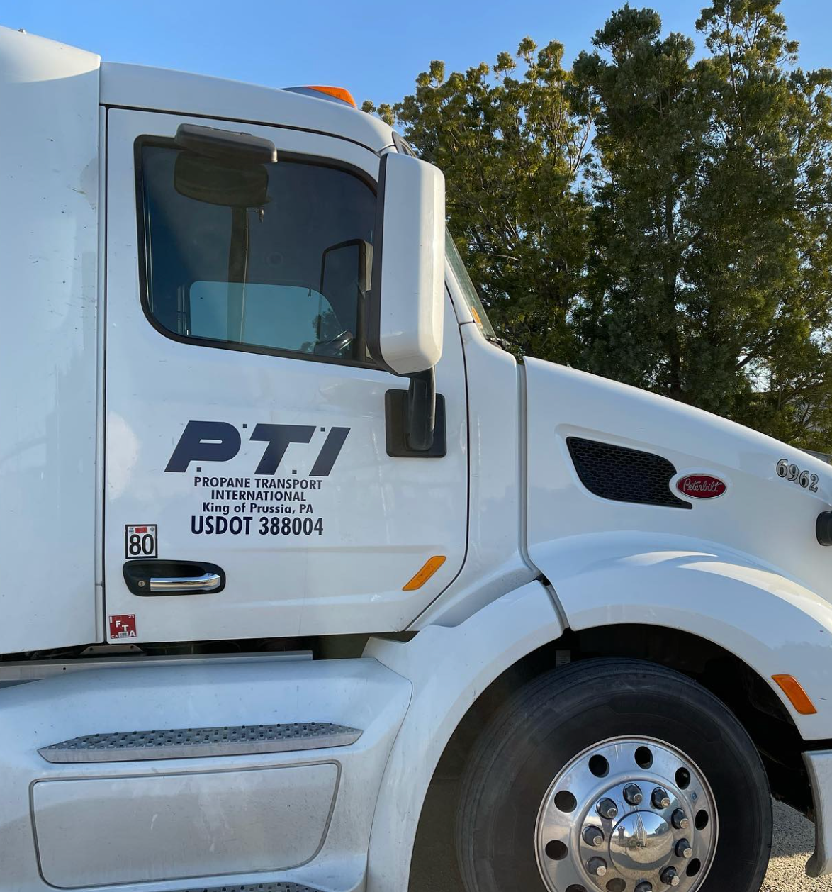 A white semi truck with the word pti on the side