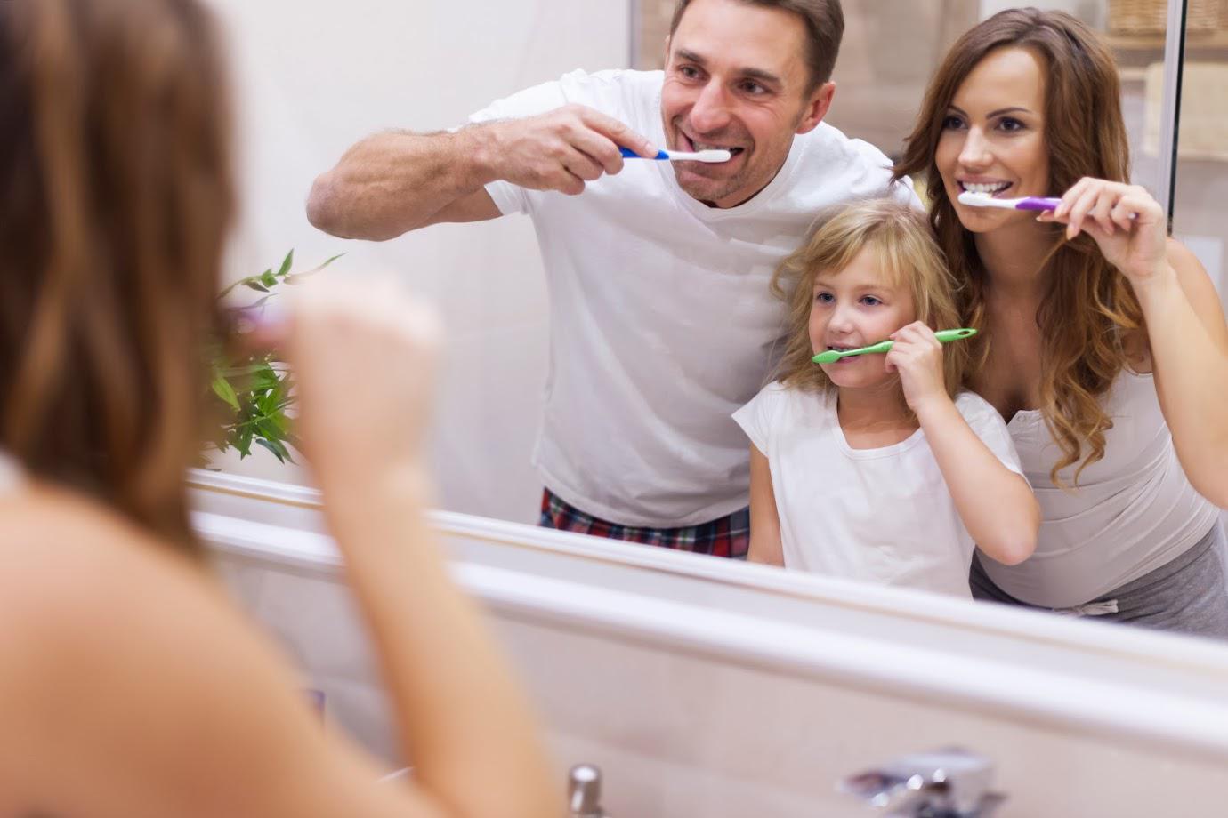Dental Services — Family in Bathroom Brushing Teeth Together in Wilmington, NC