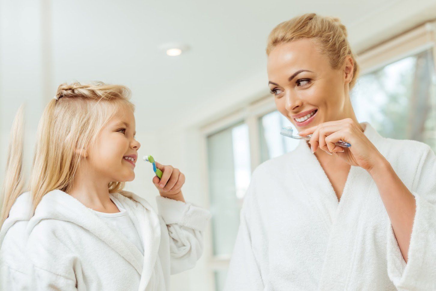 Mother and daughter brushing teeth — Wilmington, NC — Family Dental Care of Wilmington
