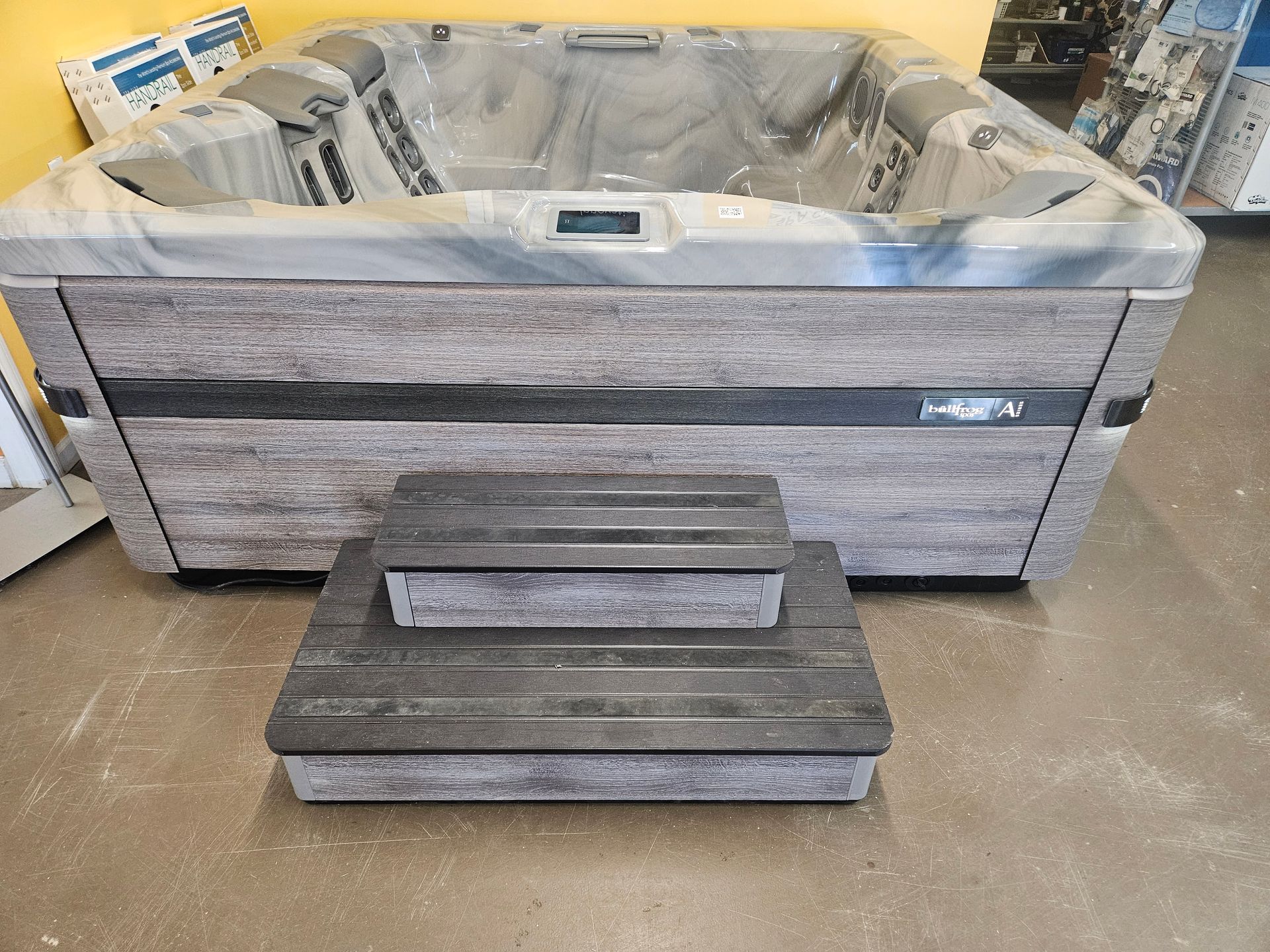 A large hot tub is sitting on the floor in a room.