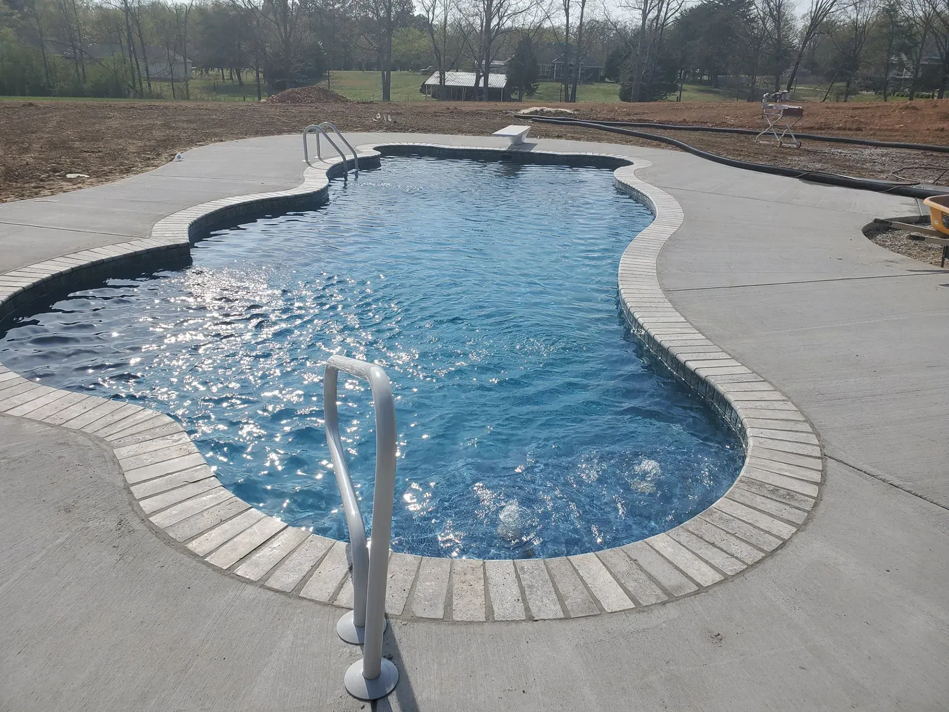 A large swimming pool with a staircase leading to it