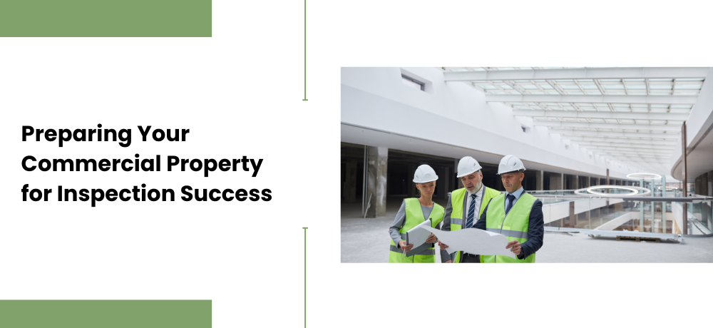 Three construction workers in hard hats and vests review blueprints in a large commercial building.