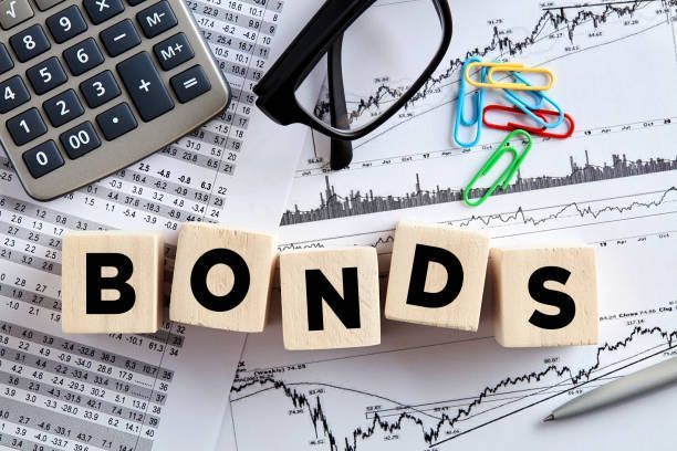 Bonds investment concept with charts, calculator, and financial analysis tools.