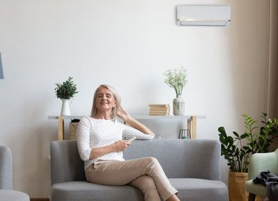 Woman Relaxing In Living Room — Farmington, AR — Super Cool Heating & Air LLC