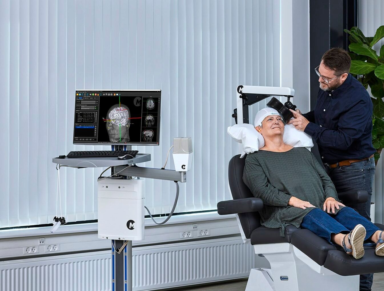 A woman is sitting in a chair while a man brushes her hair.