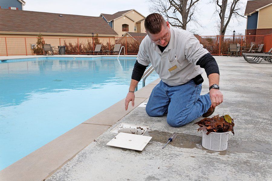 man fixing the pool drain