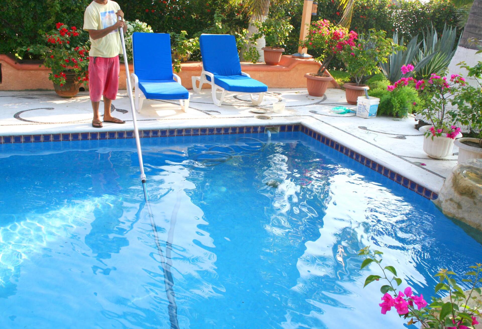 unrecognized person cleaning the swimming pool