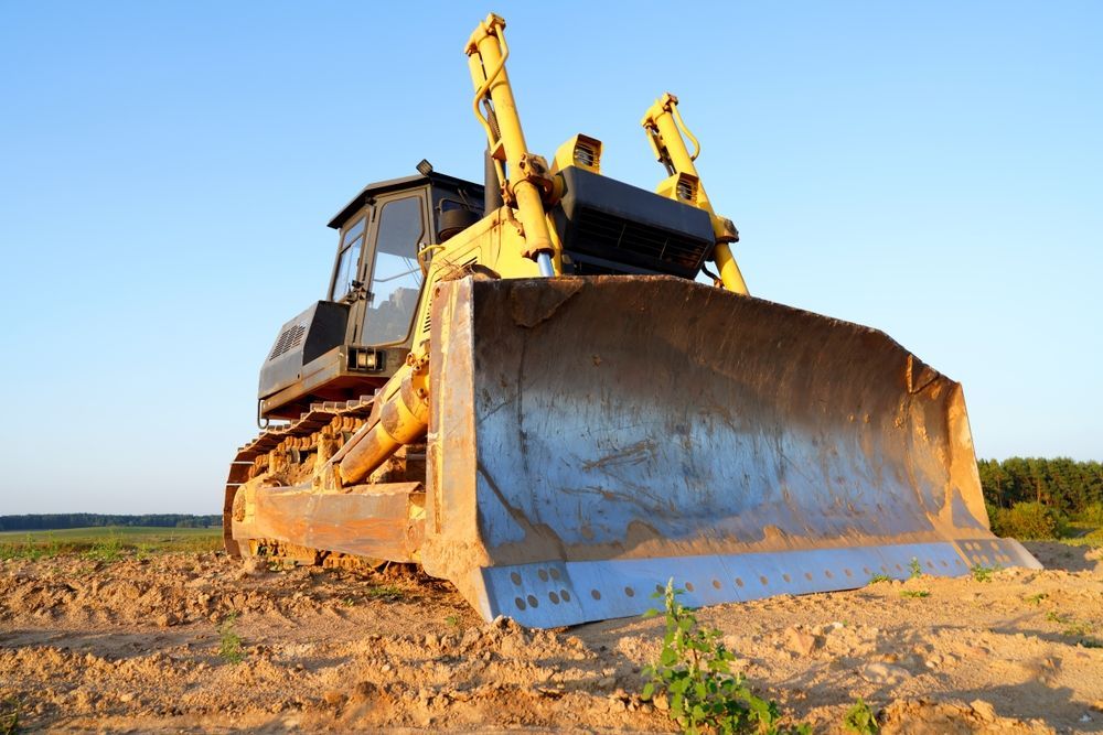 Yellow Bulldozer on Dirt Field, Preparing the Ground — ALI Civil Pty Ltd in Jervis Bay, NSW
