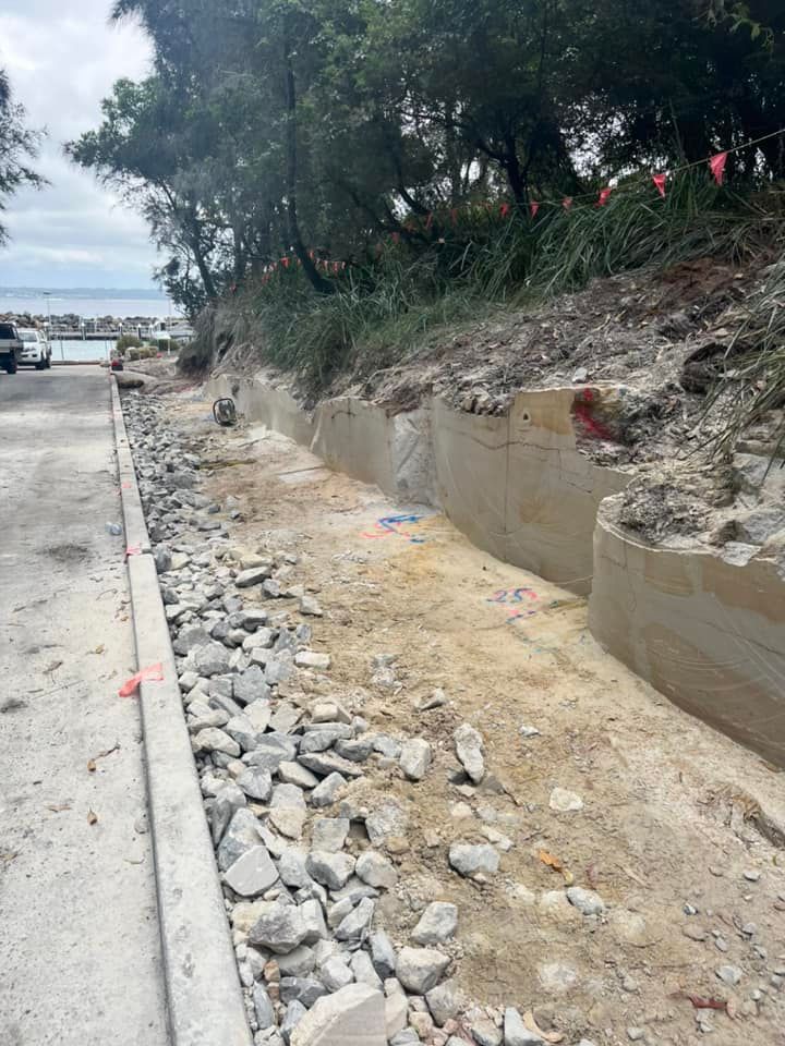 Construction Site With a Retaining Wall, Road, and Large Rocks — ALI Civil Pty Ltd in Kiama, NSW
