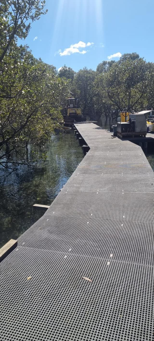 A Wooden Boardwalk Leads Over Water, Surrounded by Trees — ALI Civil Pty Ltd in South Nowra, NSW