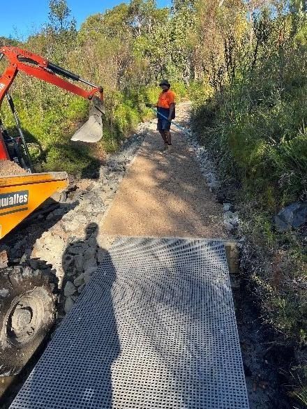 A Worker and Small Excavator Building a Gravel Path in A Natural Setting — ALI Civil Pty Ltd in South in Shellharbour, NSW