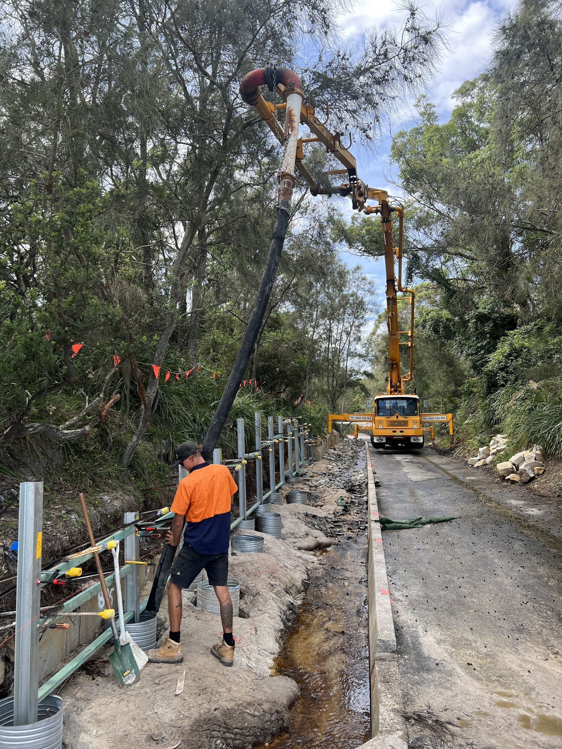 Construction Worker Using a Concrete Pump to Pour Concrete — ALI Civil Pty Ltd in South Nowra, NSW