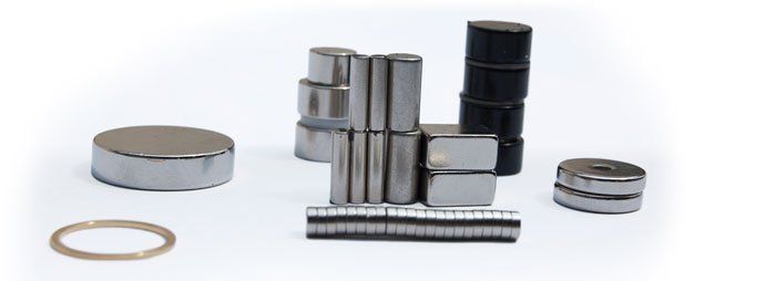 There are many different types of magnets on a white surface.