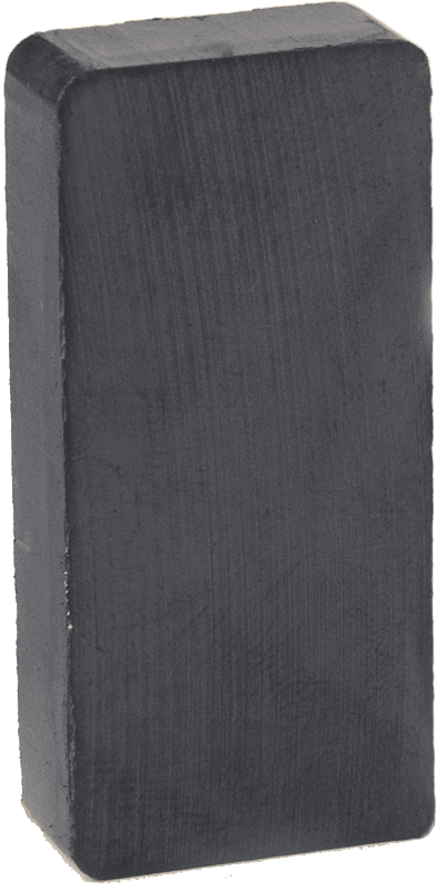 A black rectangular magnet is sitting on a white surface.