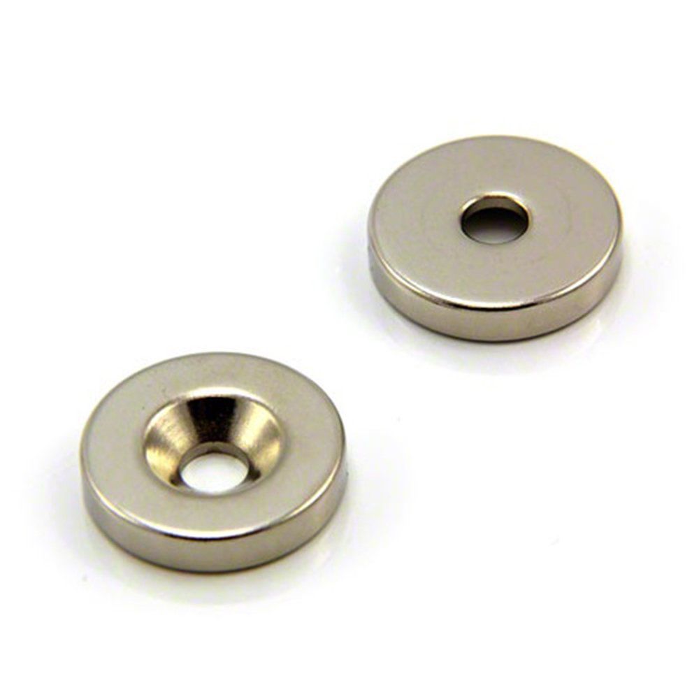 A pair of washers with a hole in the middle on a white surface.