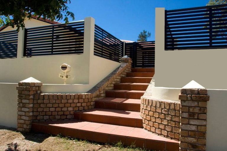 Stairs Leading Up To A House With A Black Fence — AAA Fencing & Supplies in Southport, QLD