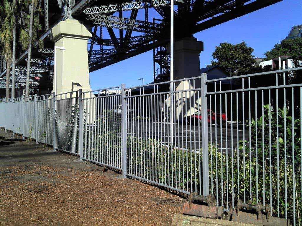 Aluminium Fence With A Bridge In The Background — AAA Fencing & Supplies in Southport, QLD