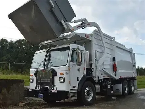 Black trash bags piled on a brick porch.