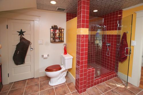 Bathroom with red tiled shower, white toilet, beige walls, and tiled floor.