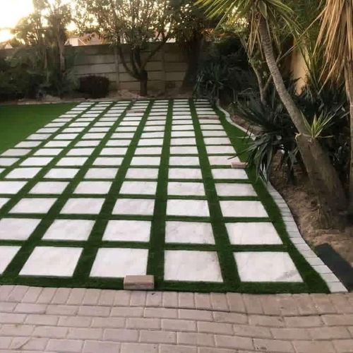 A large quarry installation walkway sitting on top of a lush green lawn.
