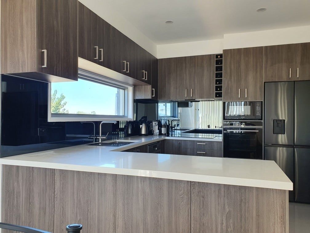 A kitchen with stainless steel appliances and wooden cabinets.
